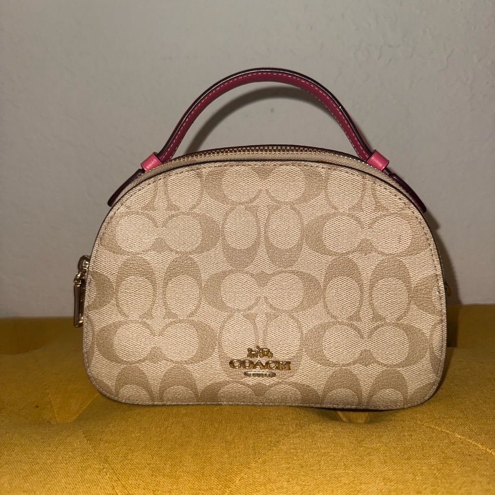 Pink ish coach clutch